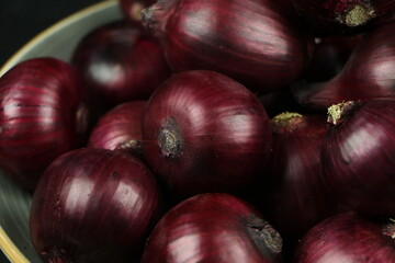 sweet red onions on background