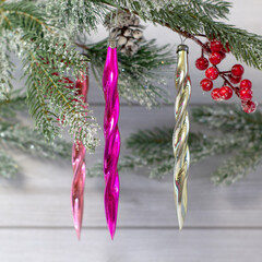 Old soviet decoration on the Christmas tree, glass toy icicles close up on light background