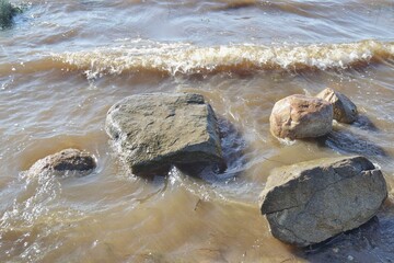 A large stones lie in water after a storm.