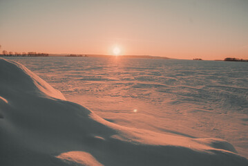 Winter Sunset over a huge snowy desert