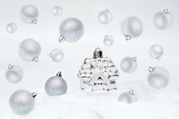 Small house and Christmas balls are flying in the air. Christmas