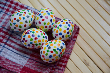 Easter eggs with colorful paint dots. Spring holiday. Easter photo background. Homemade simple painted Easter holiday eggs.