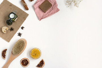 Organic cosmetics. Handemade soap. Flat lay of Body brush, sea salt, coffee, spice, oil on white background. SPA therapy at home.