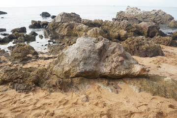 Fototapeta na wymiar unique sandstone rocks shape by the sea. Reef stone on nature background.
