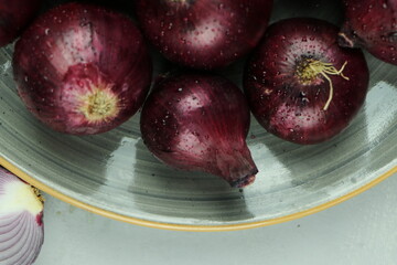 sweet red onions on background