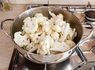 Cauliflower in steel pot in cooking. Vegan food