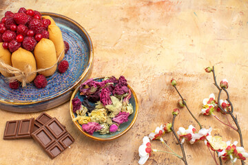 Horizontal view of freshly baked soft cake with fruits flowers and chocolate bars