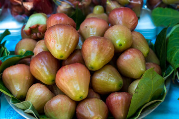 Rose apple in the market. Fresh Rose apples or Thai name is  chomphu fruit. Pile of Rose apple on sales in Thailand open market. Rose apple is a tropical fruit with sweet juicy flavor.