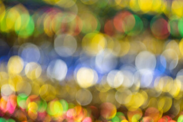 Festive colorful bokeh background. Defocused shiny sequins. Bright and multicolored texture
