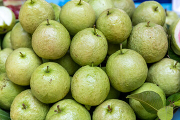 Pile of guava totaldivision to sell in the markets. Fresh guavas background. Organic green guava, sale in community store Is a fruit that is very high in vitamin C