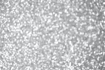 Silver abstract bokeh background. Color of the year 2021. Ultimate Grey background. Silver Christmas texture. Defocused shiny sequins.