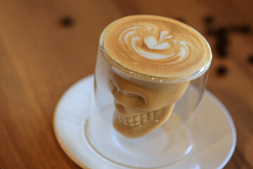 Coffee Latte Art. The coffee arts. Hot coffee in a white cup on wooden table. Hot chocolate Nutella latte art on wood table.