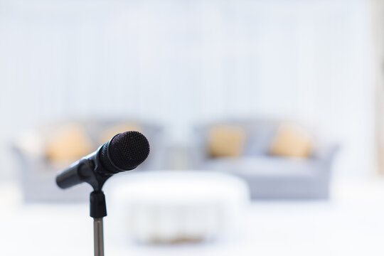 Microphone in concert hall or conference room soft and blur style for background. Microphone over the Abstract blurred photo of conference hall or seminar room background.