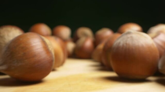 extremely close-up, detailed. background texture food. many hazelnuts on a dark background