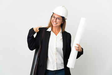 Middle age architect woman with helmet and holding blueprints over isolated background giving a thumbs up gesture