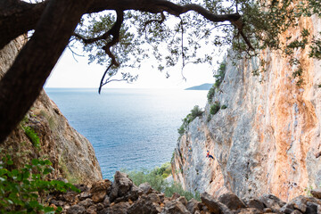 Rock climbers climbing cliff crag, Leonidio, Greece.