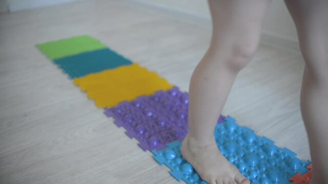 children's massage mat for physical recovery and massage of children's legs and arms. kids feet walk on the rug
