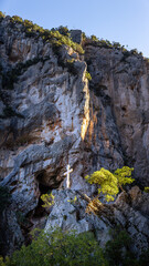 Fototapeta na wymiar Cross symbol monument on mountain cliff.