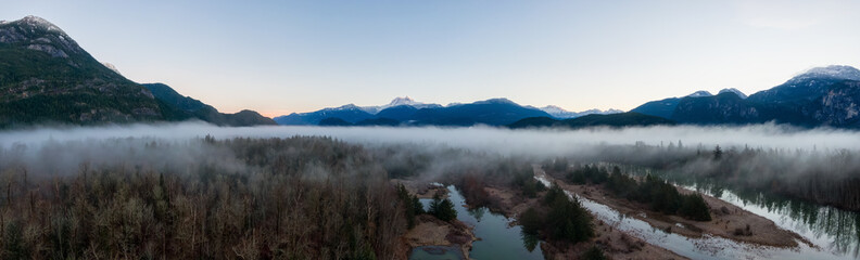 Aerial Panoramic Canadian Nature Landscape with mountains in background. Sunny Sunrise Sky. Taken...