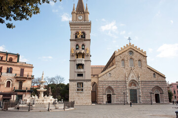 Square of the cathedral with the majestic basilica, the belfry with the astronomical clock,  and...