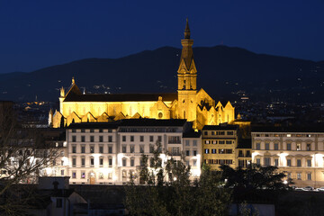 Fototapeta na wymiar Night cityscape view of Florence, in Italy with illuminated Basilica of the Holy Cross.