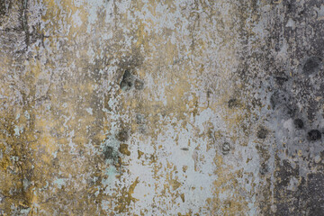 Old dirty yellow and white peeling paint wall texture.