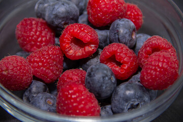ripe red raspberries and dark blue blueberries