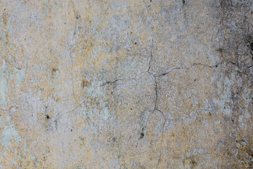 Old dirty yellow and white peeling paint wall texture.