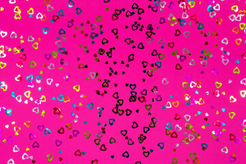 Pink background with colorful hearts. Love concept, Valentine's Day greeting card. View from above. The basis for the postcard.