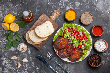 top view meat cutlets with salad and bread on grey background dish photo food