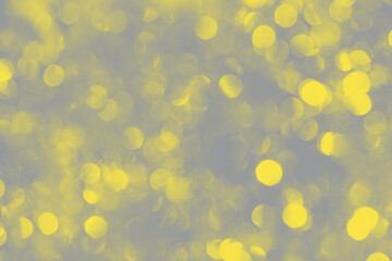 Blurry, defocused multicolored lights. Showcasing the trendy colors of 2021 - gray and yellow....