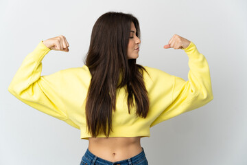 Teenager Brazilian girl isolated on white background doing strong gesture