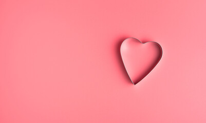 Heart on a delicate Pink background. Top view with copy space, panorama. Concept of February 14, love.