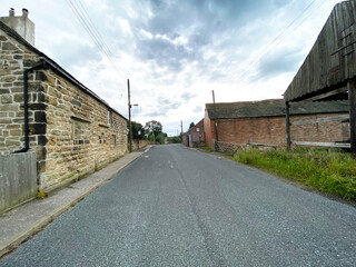 Houses, and farm buildings, under a cloudy sky in, Wintersett, Wakefield, UK