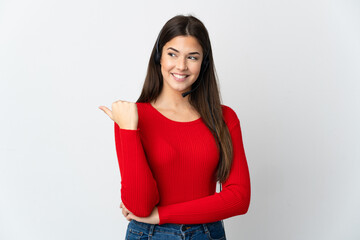 Young Brazilian telemarketer girl over isolated background pointing to the side to present a product