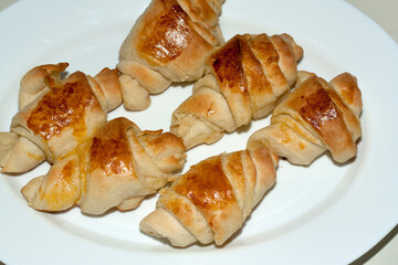 Fresh homemade croissants on white plate
