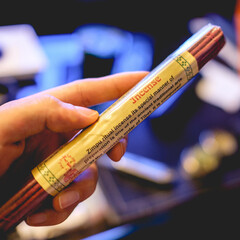 Hand holding natural and handmade incense sticks from Tibet