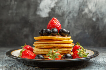 front view delicious pancakes with fruits and berries on dark background fruit cake dessert