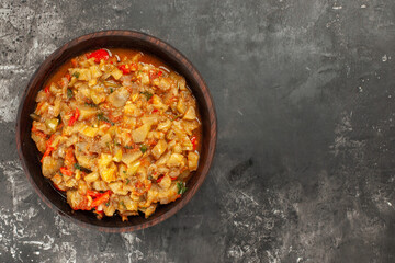 top view roasted eggplant salad on dark background with copy space