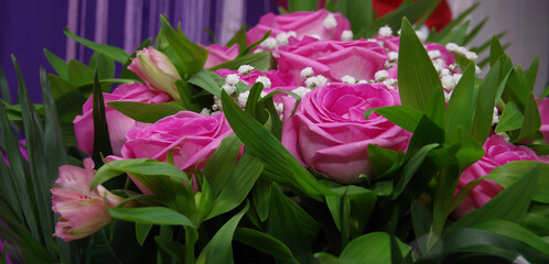 Beautiful bouquet of pink roses for birthday. Various flowers for the holiday. Close-up. Selective focus. Baner, wallpaper, postcard.