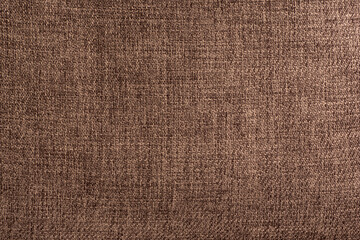 Fototapeta na wymiar Rough textile texture. Brown fabric close up