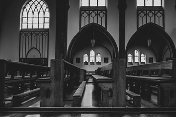 Empty benches in a church, empty prayer benches in a church, black and white photo