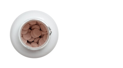 Vitamins in a plastic jar top view