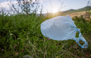 Plastic bag on the ground in nature. Close up, ecological problem, concept of environmental...