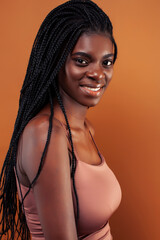 pretty young african american woman posing cheerful gesturing on brown background, lifestyle people concept