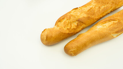 Fresh and crispy French baguettes on a white plate. Isolate