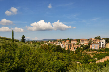 Scenic view of a residential area on the hills adjacent to the historic center of Siena in a sunny summer day, Tuscany, Italy