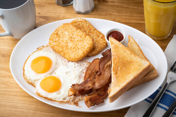 american breakfast with egg, bacon, hash brown and toast