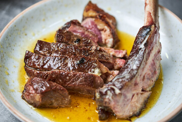 Cooking juicy beef steak by chef hands on dark black background with space for text menu or recipe