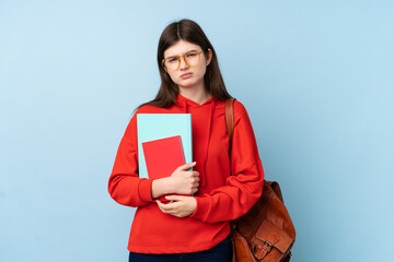 Obraz premium Young Ukrainian teenager student girl holding a salad over isolated blue background sad
